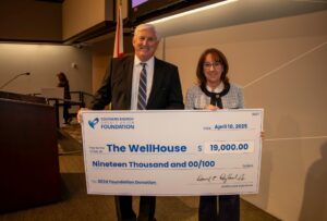 The Wellhouse Representative accepts check for $19,000 from Southern Energy CU CEO, Derrick Ragland. 