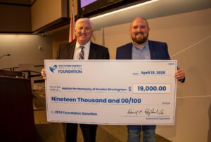 Habitat for Humanity of Greater Birmingham Representative accepts check for $19,000 from Southern Energy CU CEO, Derrick Ragland. 