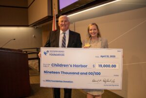 Children's Harbor Representative accepts check for $19,000 from Southern Energy CU CEO, Derrick Ragland. 