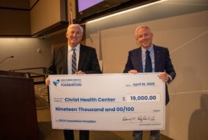 Christ Health Center Representative accepts check for $19,000 from Southern Energy CU CEO, Derrick Ragland. 