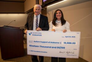 Autism Support of Alabama Representative accepts check for $19,000 from Southern Energy CU CEO, Derrick Ragland. 